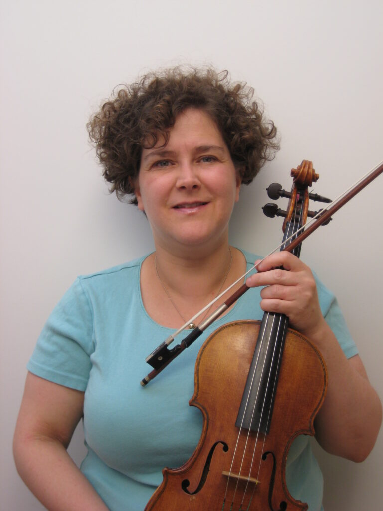 Amy smiling, posing with violin